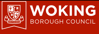Woking Borough Council logo presenting a shield with symbols, displayed on a red background.